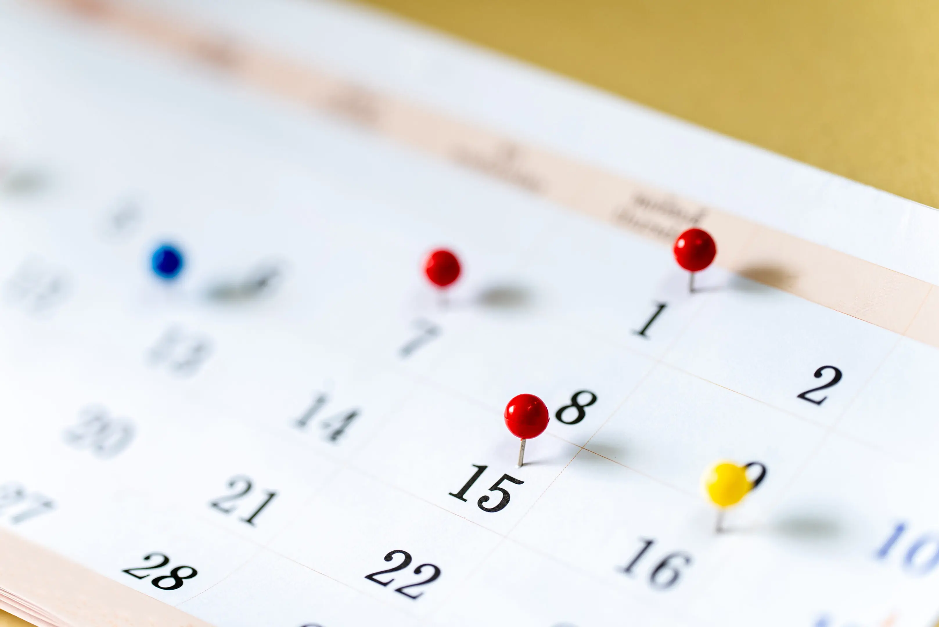 A calendar with many pins on it