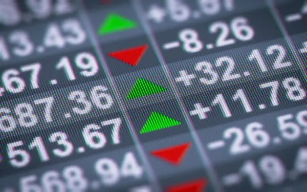 A close up of the numbers on a stock market board.
