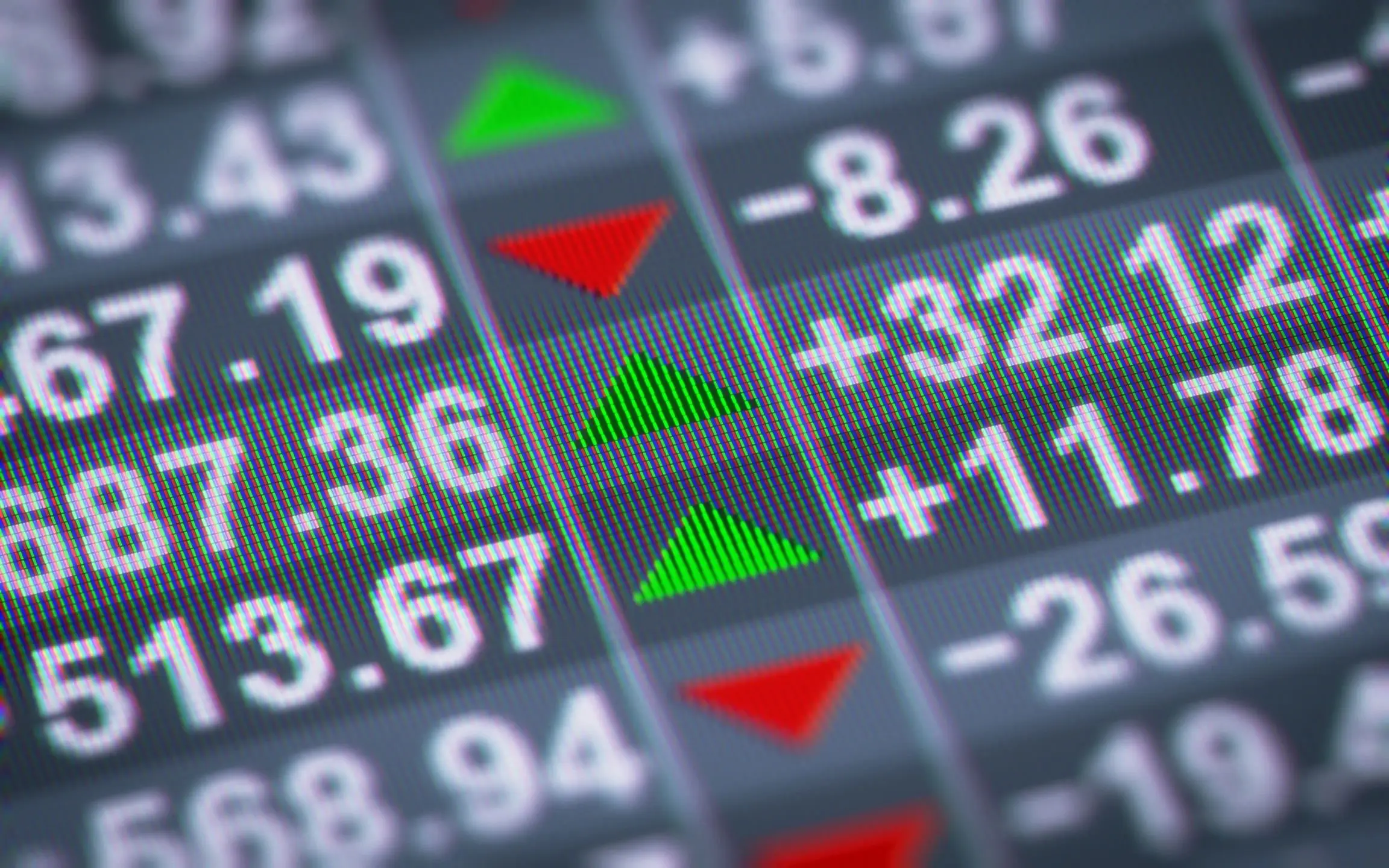 A close up of the numbers on a stock market board.